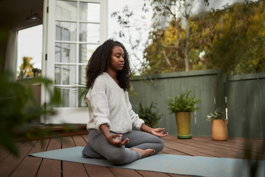 young woman meditating as relaxing exercise for anxiety