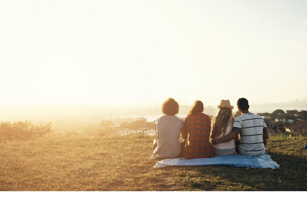 group of young people recovering from social anxiety disorder having picnic on grass