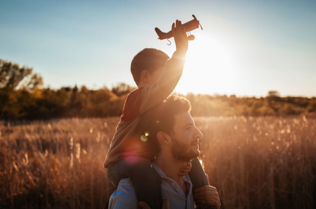man with son playing in field wondering if anxiety is genetic