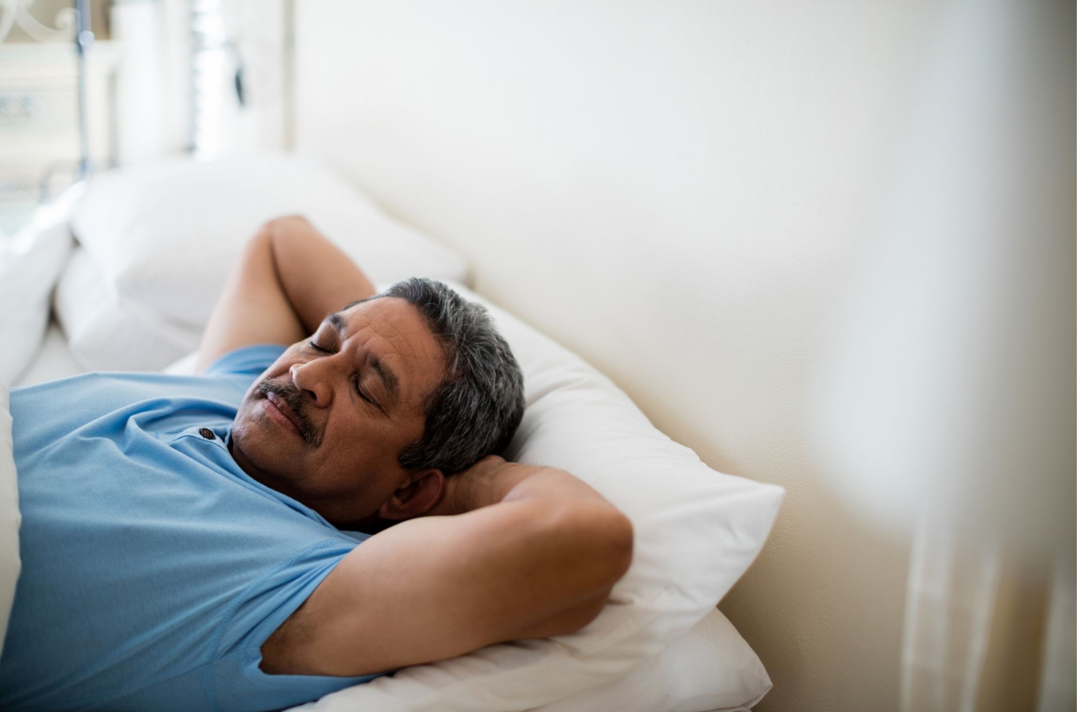 older man in bed sleeping after taking melatonin for anxiety