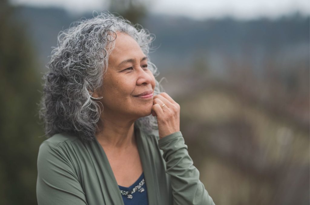 older woman with slight smile understanding what anxiety means