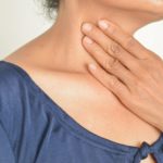 woman with hand on neck to represent feelings of extreme anxiety