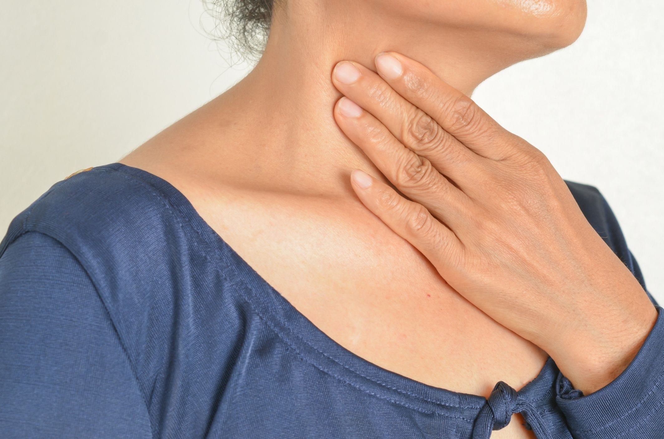 woman with hand on neck to represent feelings of extreme anxiety