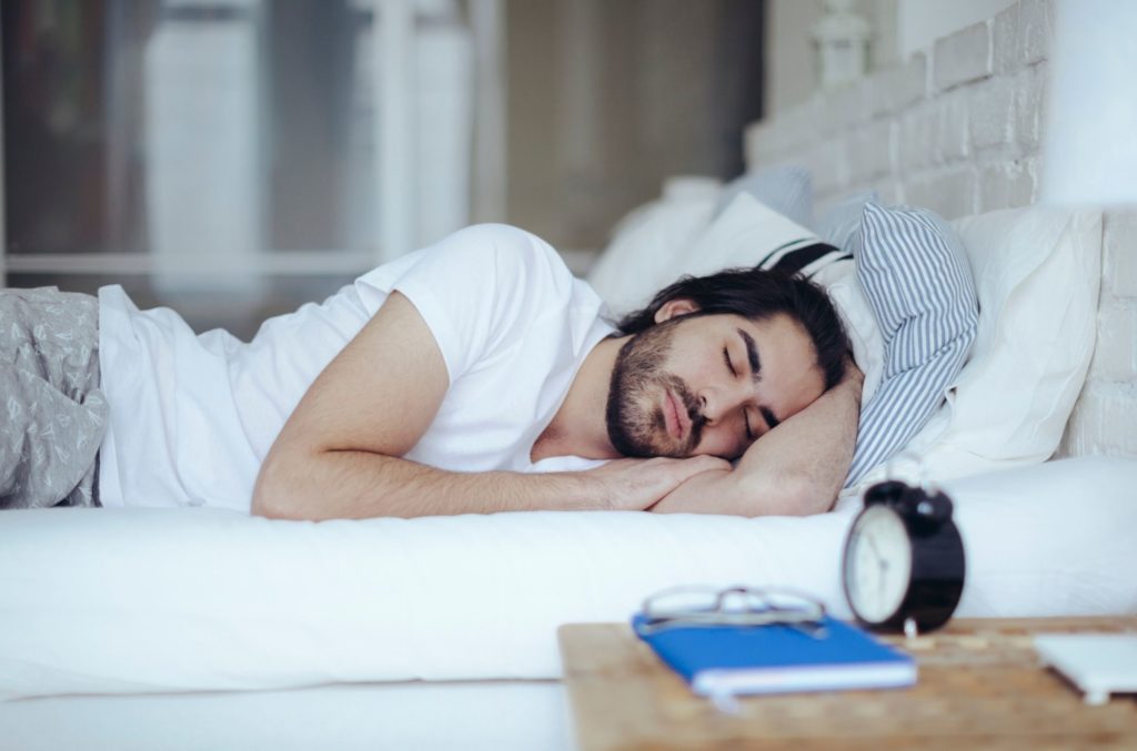 man in bed resting with sleep disorder diagnosis based on definition of insomnia