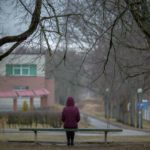 woman sitting on park bench experiencing anger and depression