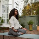 young woman meditating as relaxing exercise for anxiety