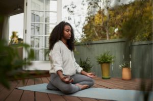 young woman meditating as relaxing exercise for anxiety