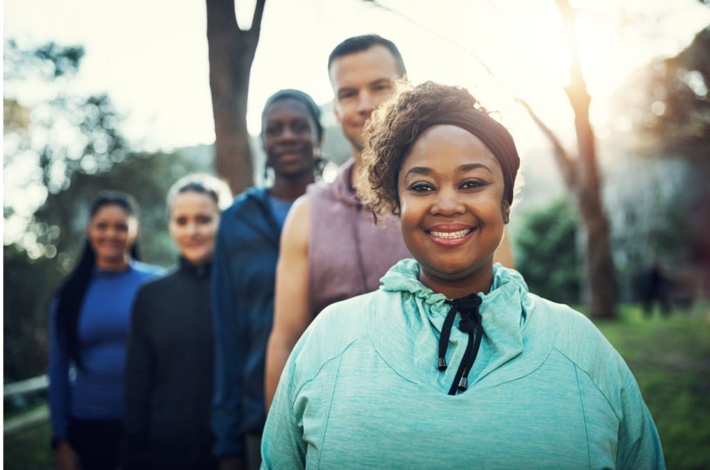 diverse group outside exercising to lower blood pressure naturally