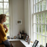 Image of a woman looking out a window considering birth control options