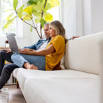 A couple at home using a laptop, researching information on erectile dysfunction and its impact on relationships.