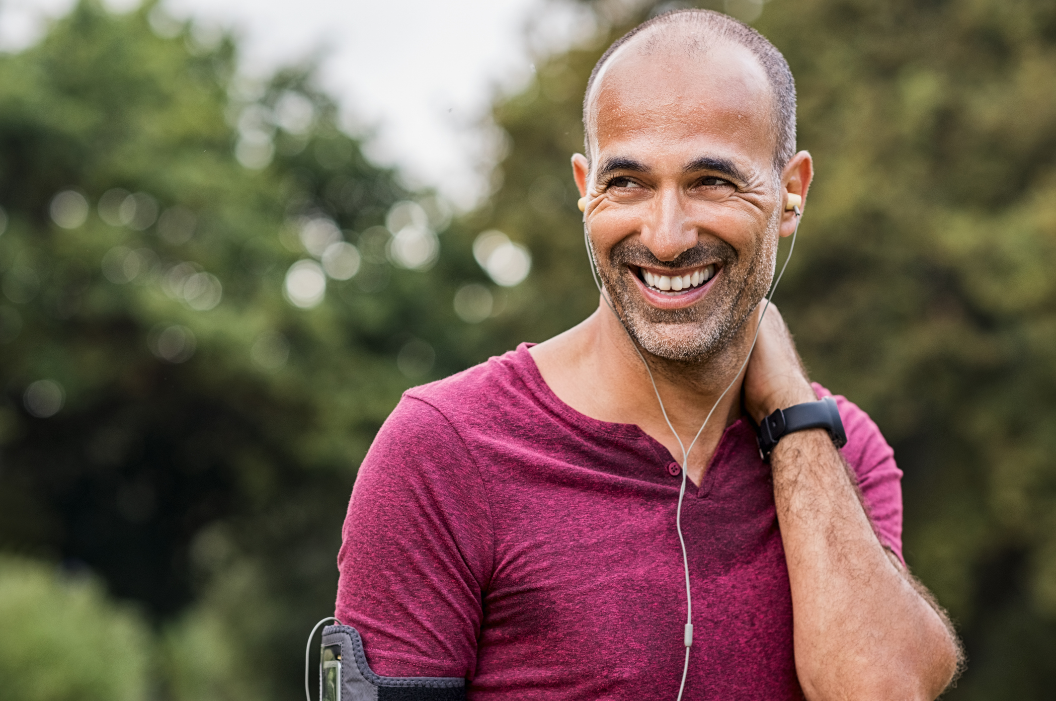 A man with thinning hair exercising outside, contemplating his hair loss treatment options, such as finasteride and minoxidil, while considering the best approach for effective results.