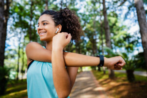 A woman stretching on a sidewalk before a run, symbolizing an active lifestyle and heart health, reflecting the importance of understanding cholesterol for overall well-being.