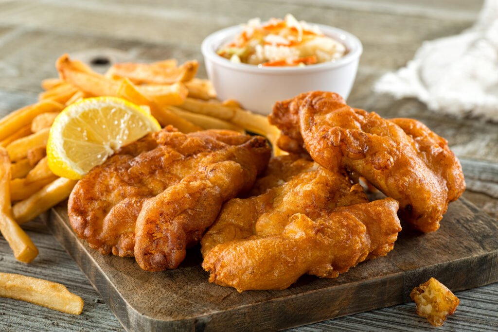 Plate of fish and chips, highlighting one of the high-cholesterol foods to avoid for better heart health