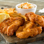 Plate of fish and chips, highlighting one of the high-cholesterol foods to avoid for better heart health