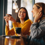 Women meeting at a coffee shop, representing open discussions and shared advice on birth control options