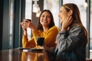 Women meeting at a coffee shop, representing open discussions and shared advice on birth control options