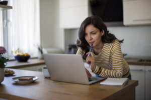 A woman researching birth control options on her laptop, comparing different choices to determine which one is the best fit for her health and lifestyle.