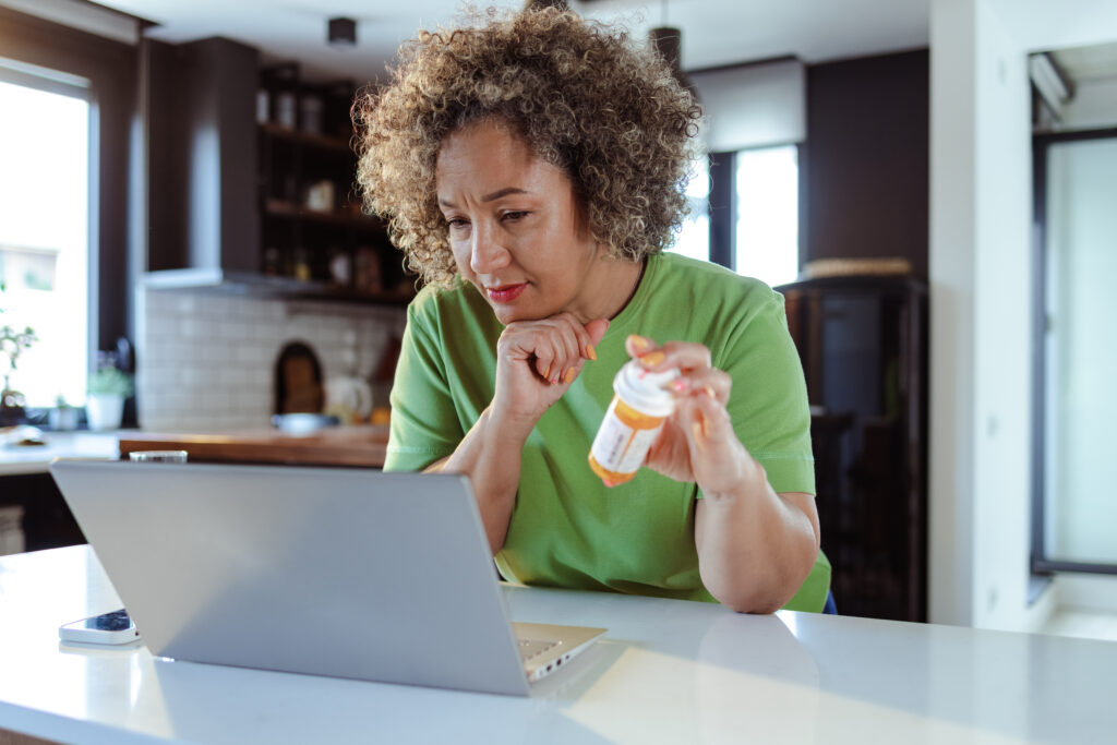 A person reading information online, reflecting the importance of understanding the risks of combining alcohol with Lexapro®, including potential liver issues and worsened depression.