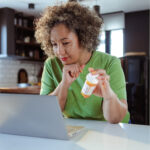 Woman reading information about anxiety medication online, exploring treatment options for managing anxiety symptoms.