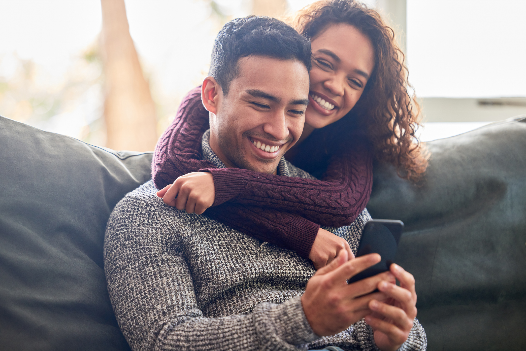 Couple reviewing Viagra® information on a cellphone together, highlighting the importance of discussing usage, dosage, and lifestyle adjustments for optimal effectiveness.