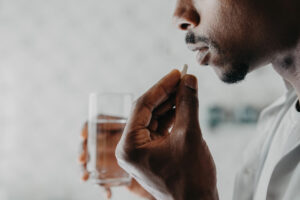 Man taking medication at home, reflecting the process of starting Lexapro® (escitalopram) to manage depression and anxiety