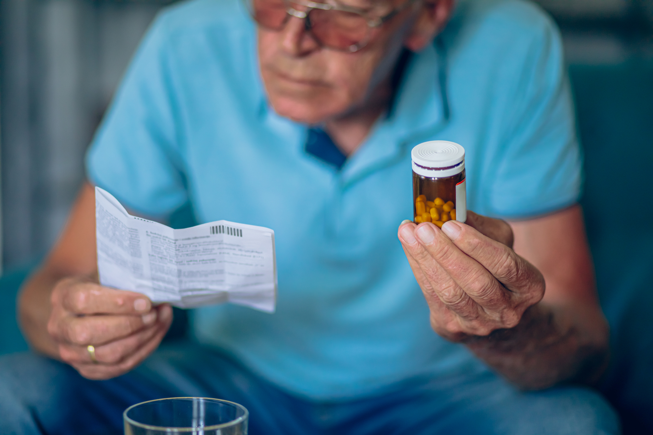 Man reading Stendra® instructions at home, emphasizing the importance of understanding the medication’s usage and potential risks before taking it.